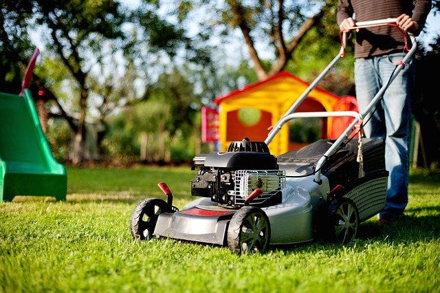 Man mowing lawn with real grass